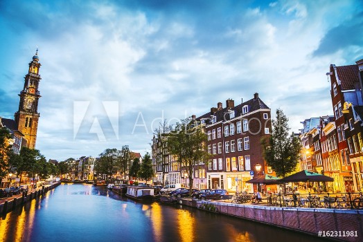 Picture of The most famous canals and embankments of Amsterdam city during sunset General view of the cityscape and traditional Netherlands architecture